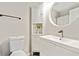Modern bathroom with a round mirror, sleek vanity, and updated fixtures at 2376 Wellington Cir, Lithonia, GA 30058