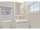 Stylish bathroom featuring a modern sink, mirror, and toilet with updated fixtures at 2376 Wellington Cir, Lithonia, GA 30058