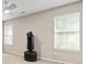 Bright bedroom with a ceiling fan, neutral paint, and multiple windows with blinds at 2376 Wellington Cir, Lithonia, GA 30058