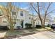 Street view of a well-maintained two-story townhome, featuring a small porch, neat landscaping, and easy parking access at 2376 Wellington Cir, Lithonia, GA 30058