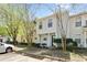 Street view of a well-maintained two-story townhome, featuring a small porch, neat landscaping, and easy parking access at 2376 Wellington Cir, Lithonia, GA 30058