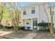 Charming two-story townhome with a welcoming front porch and mature landscaping creating an inviting curb appeal at 2376 Wellington Cir, Lithonia, GA 30058