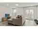 Inviting living room with sleek floors, modern fireplace, and ample natural light streaming through french doors at 2376 Wellington Cir, Lithonia, GA 30058