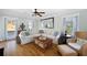 Cozy living room featuring a sectional sofa, ceiling fan, and natural light at 3932 Sentry Walk, Marietta, GA 30068