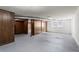 Basement area with concrete floor, exposed ducts, wood paneling and a window at 415 Creek Valley Dr, Woodstock, GA 30188