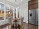 Cozy breakfast nook with a round table, four chairs, and natural light from the large windows, adjacent to the kitchen at 551 Verismo Way, Alpharetta, GA 30009