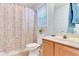 Bathroom with toilet, vanity, patterned shower curtain, and window at 1029 Daventry Xing, Woodstock, GA 30188