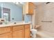 Bright bathroom featuring a vanity with a sink, a toilet, and a shower with built-in seat at 1029 Daventry Xing, Woodstock, GA 30188