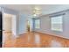 Spacious bedroom with a ceiling fan and two windows for natural light, next to an ensuite bathroom at 1029 Daventry Xing, Woodstock, GA 30188