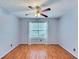 Bedroom with hardwood floors, ceiling fan, and large window at 1029 Daventry Xing, Woodstock, GA 30188