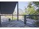 Enjoy neighborhood views from this balcony with modern railings and a comfortable outdoor rug at 179 South Se Ave, Atlanta, GA 30315