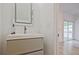 Modern bathroom features a sleek vanity with a gray cabinet and a contemporary illuminated mirror at 179 South Se Ave, Atlanta, GA 30315