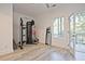 Bright workout room offers a full gym set, full-length mirror and balcony doors for natural light at 179 South Se Ave, Atlanta, GA 30315