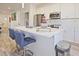 Stylish kitchen island with seating, stainless steel appliances and modern white cabinets at 179 South Se Ave, Atlanta, GA 30315