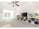 Bright bonus room featuring a large window, storage shelves with blue accents, and a modern ceiling fan at 3034 Farmington Se Dr, Atlanta, GA 30339