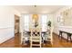 Bright dining room with wood flooring, modern light fixture, and decorative wall art at 3034 Farmington Se Dr, Atlanta, GA 30339