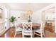 Formal dining room with hardwood floors, modern chandelier, and views into kitchen at 3034 Farmington Se Dr, Atlanta, GA 30339