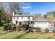 Charming home with a lush front yard, complemented by mature landscaping and a classic white facade at 3034 Farmington Se Dr, Atlanta, GA 30339