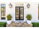 Inviting front door with stone steps, black framed windows, and potted shrubbery at 3034 Farmington Se Dr, Atlanta, GA 30339