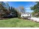 Expansive front yard view showcasing the home's manicured lawn and inviting curb appeal on a sunny day at 3034 Farmington Se Dr, Atlanta, GA 30339