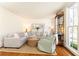 Cozy living room featuring a sectional sofa, wicker coffee table, and natural light at 3034 Farmington Se Dr, Atlanta, GA 30339