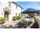 Inviting outdoor patio with comfortable seating under an umbrella, surrounded by manicured greenery and charming brickwork at 3034 Farmington Se Dr, Atlanta, GA 30339