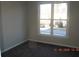 Bedroom features natural light streaming through a large window overlooking the neighborhood at 3975 Broadleaf Walk, Ellenwood, GA 30294