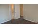 Neutral bedroom showcasing carpet, white doors and walls, and natural light at 3975 Broadleaf Walk, Ellenwood, GA 30294