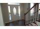 Entryway with hardwood floors, staircase, and decorative front door at 3975 Broadleaf Walk, Ellenwood, GA 30294