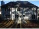 Rear view of a two-story home with a neutral color scheme and a patio at 3975 Broadleaf Walk, Ellenwood, GA 30294