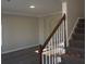 Carpeted staircase with white railing leading to the second floor at 3975 Broadleaf Walk, Ellenwood, GA 30294