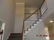 View of the carpeted staircase with white and brown trim and light grey walls at 3975 Broadleaf Walk, Ellenwood, GA 30294