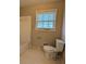 Functional bathroom with white fixtures, tiled floor, and natural light at 8271 Walnut Dr, Jonesboro, GA 30238