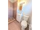 Cozy bathroom features a tiled shower, single sink, and toilet at 8271 Walnut Dr, Jonesboro, GA 30238