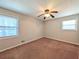 Bedroom features neutral walls and brown carpet and windows provide natural light at 8271 Walnut Dr, Jonesboro, GA 30238