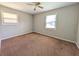 Bedroom with neutral walls, brown carpet and two windows for natural light at 8271 Walnut Dr, Jonesboro, GA 30238