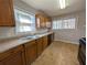 Functional kitchen with laminate countertops, wood cabinets, and black appliances at 8271 Walnut Dr, Jonesboro, GA 30238