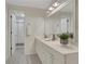 Bathroom features a large mirror, quartz countertop, white cabinets, and tile floors at 9 Ivy Gates Ne, Atlanta, GA 30342