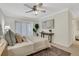 This neutral bedroom features shutters, modern lighting, a ceiling fan and contemporary furnishings at 9 Ivy Gates Ne, Atlanta, GA 30342