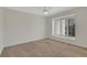 Empty bedroom with neutral carpet, white walls, and a window with blinds at 9 Ivy Gates Ne, Atlanta, GA 30342