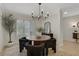 Dining room with modern chandelier and table surrounded by plush chairs at 9 Ivy Gates Ne, Atlanta, GA 30342