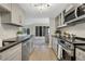 Bright kitchen with stainless steel appliances, gray cabinets, and access to the living room at 9 Ivy Gates Ne, Atlanta, GA 30342