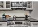 Close up of the stainless steel oven and microwave with gray cabinets in this modern kitchen at 9 Ivy Gates Ne, Atlanta, GA 30342