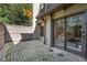 A fenced patio area with mossy pavers and a sliding glass door at 9 Ivy Gates Ne, Atlanta, GA 30342