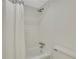 The shower features a neutral shower curtain, white tile, and chrome fixtures at 9 Ivy Gates Ne, Atlanta, GA 30342