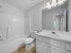 Clean, white bathroom features a tub and shower combination, vanity, and a large mirror at 1486 Waterton Trl, Douglasville, GA 30134