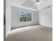 Bright main bedroom with a ceiling fan and a large window offering ample natural light and comfortable carpeting at 1486 Waterton Trl, Douglasville, GA 30134