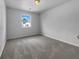 Simple bedroom with soft carpeting and a window that lets in natural light and outlets at 1486 Waterton Trl, Douglasville, GA 30134