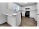 A bright kitchen featuring white cabinets, modern appliances, and sleek countertops, offering a functional design at 1486 Waterton Trl, Douglasville, GA 30134