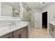 The renovated bathroom includes a frameless shower, modern finishes, and updated hardware at 2125 Burnside Nw Dr, Atlanta, GA 30318